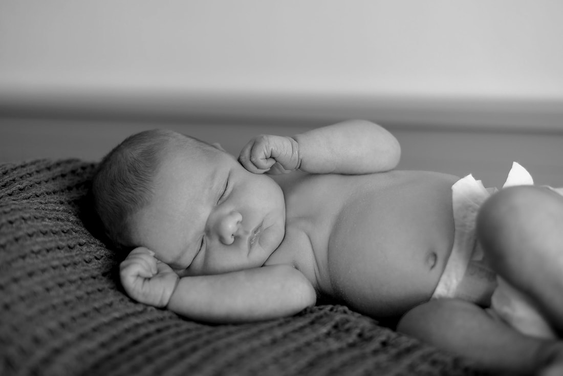 black and white image of baby sleeping 