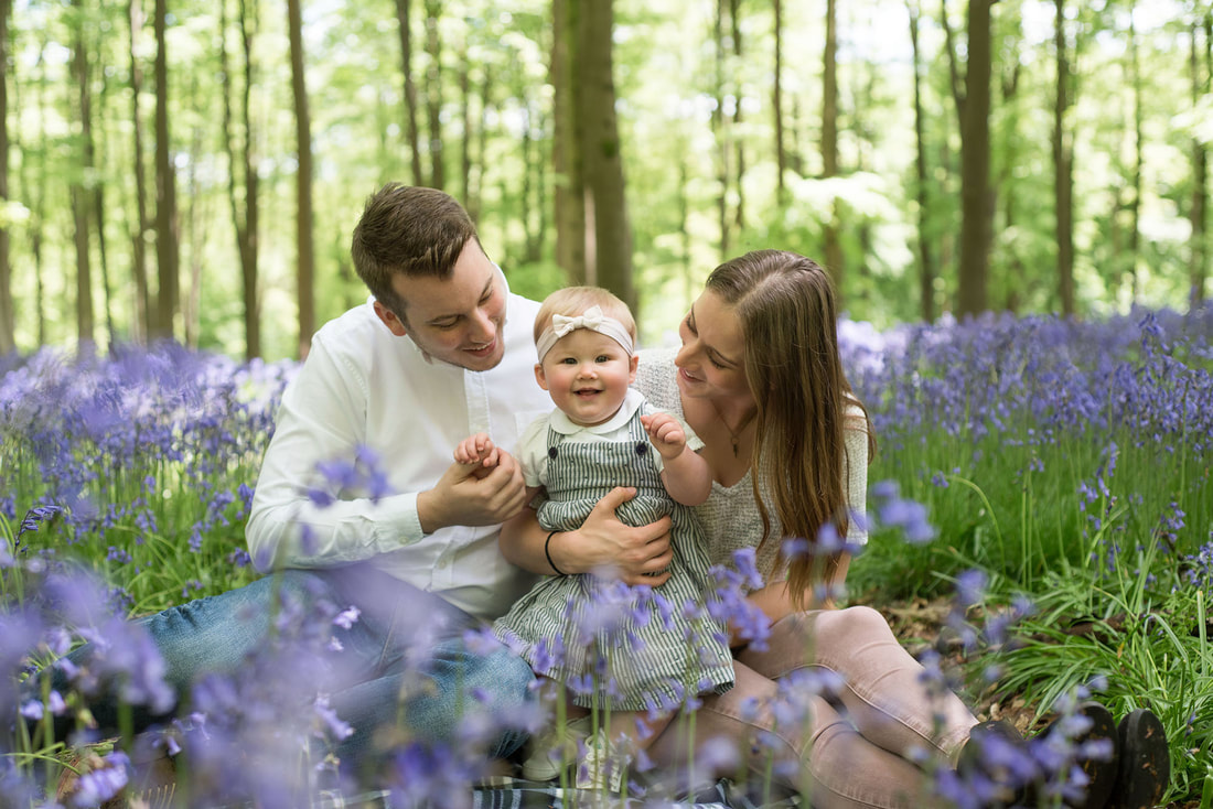 young baby with man and woman St in bluebells 