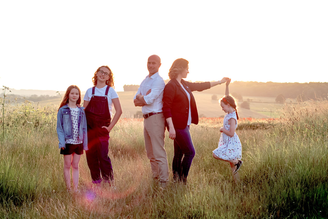 family of 5 at sunset in field 