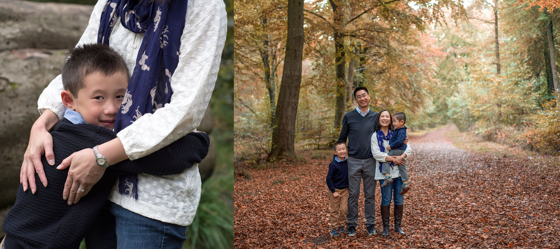 boy hugging his mum and family standing together in autumn leaves 